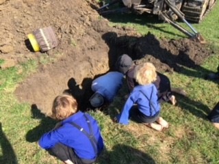 WW-0012
Photo Date: August 9, 2018
Photo Credit: Joe Rakoczy
Description: During a recent soil investigation in a rural county, 3 young children seem fascinated with what that person is doing in that hole. 
