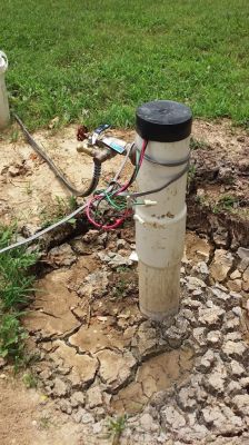 GW-0001
Photo Date: 8-17-16
Photo Credit: Ginger Harrington, Hendricks County Health Department
Description: During an inspection of a well, this is what was found.  The cap is only a temporary cap that should not be utilized on a functioning well.  Typically this cap is installed after the well is drilled but before the pump is installed.  All of the wiring is open and exposed.
