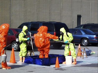 ER-0012
Photo Date: 7/5/2015
Photo Credit: Jason Ravenscroft
Description: Emergency responders decontaminating the entry team of a response in Level A gear.

