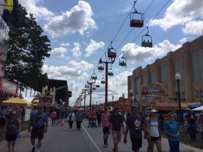 FS-0039
Photo Date: 08/12/17
Photo Credit: Lisa Harrison
Description: Photo of the new Sky Ride at the Indiana State Fair. It also shows a typical temporary food scene with people and food booths.
