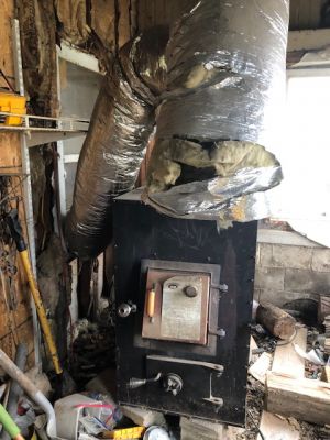 HH-0037B
Photo Date: 6/19/19
Photo Credit: Adrianne Northcutt
Description: Individual that was living in the home had a wood stove out on the front porch, had cut a hole in the porch roof to vent part of the stove, the other part was coming in the bedroom window.  

