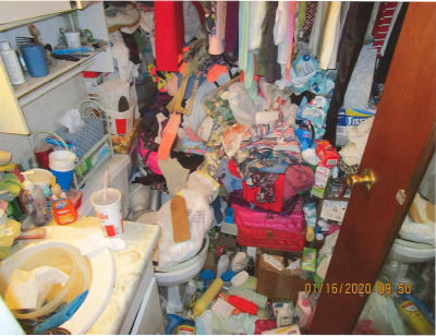 HH-0043
Photo Date: January 16, 2020
Photo Credit: Jeff Couch and Peggy Bradley
Description: The photo was taken in the only bathroom in the house. There is a bathtub in this picture filled with clothes and other stuff.  The whole house was piled almost to the ceiling.  
