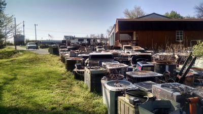 HS-0005
Photo Date:	4/12/2017
Photo Credit:	Alan Martin 
Description:	This picture was from a complaint that I had received. The property owner was recycling the metals and chiefly copper. Each of these old A/C units had been onsite for a year. I found that the bases of these units were holding enough water that I found mosquito larvae in April. The grass was cut and the balance of the yard was well maintained except for the HVAC graveyard.
