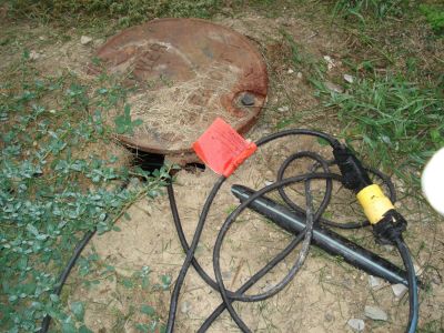 OWS-0001
Photo Date:	9/21/2012
Photo Credit: Jason Ravenscroft
Description: Septic  tank with riser that was not waterproof on a commercial property.  Property owner had pump set up to discharge septic tank to surface water when full.

