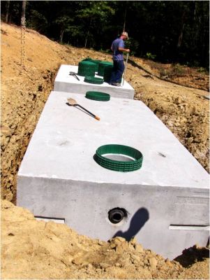 OWS-0039A
Photo Date: 8/19/2012
Photo Credit: Jennifer Heller
Description: A camp in Brown County installed an eight bed Presby system with 2-6,000 gallon tanks. This picture is the second tanks lid installation. 
