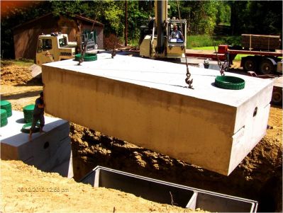 OWS-0039B
Photo Date: 8/19/2012
Photo Credit: Jennifer Heller
Description: A camp in Brown County installed an eight bed Presby system with 2-6,000 gallon tanks. This picture is the second tanks lid installation. 
