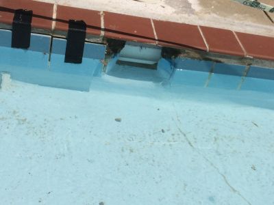 POOL-0023
Photo Date:	6/28/2016
Photo Credit:	Jason Ravenscroft
Description:	Broken pool coping and tile held together with tape.

