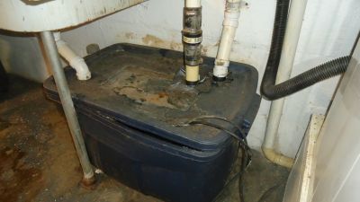 WW-0007a
Photo Date: March 26, 2018
Photo Credit: Anna Doerflein
Description: Plastic tote used to collect sink and laundry water and pump to sewer.  
