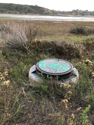 WW-0015
Photo Date:	December 23 2019
Photo Credit:	Jennifer Heller
Description:	The riser on a sewer line in the Batiquitos Lagoon near San Diego California.  There is a walking path along the edge of the lagoon
