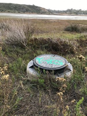 WW-0015
Photo Date:	December 23 2019
Photo Credit:	Jennifer Heller
Description:	The riser on a sewer line in the Batiquitos Lagoon near San Diego California.  There is a walking path along the edge of the lagoon
